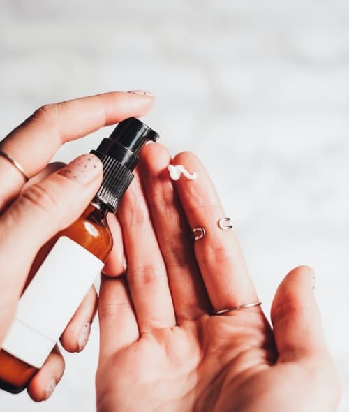 Hands holding a skincare product
